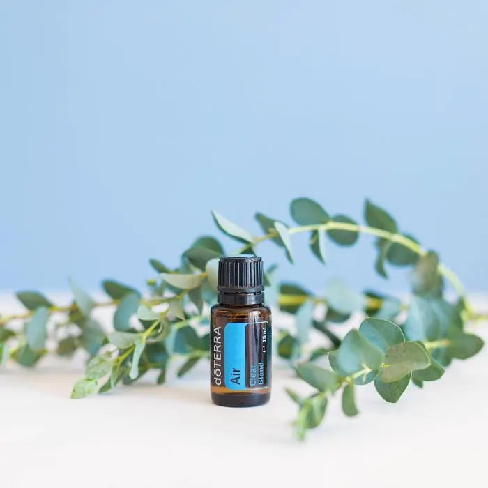 Air 15ml de doTERRA en fondo azul con una rama eu eucalipto