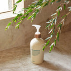 Acondicionador Diario dōTERRA 500ml — frasco en baño sobre mármol