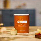 Bote doTERRA Fibre 315 g con cacito medidor lleno de polvo de fibra sobre encimera de cocina