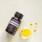 Frasco de Cápsulas Blandas CP+ dōTERRA con softgels en cuenco de cristal sobre fondo beige