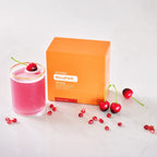MetaPWR™ Advantage dōTERRA cereza y granada — sobre junto a vaso ya preparado