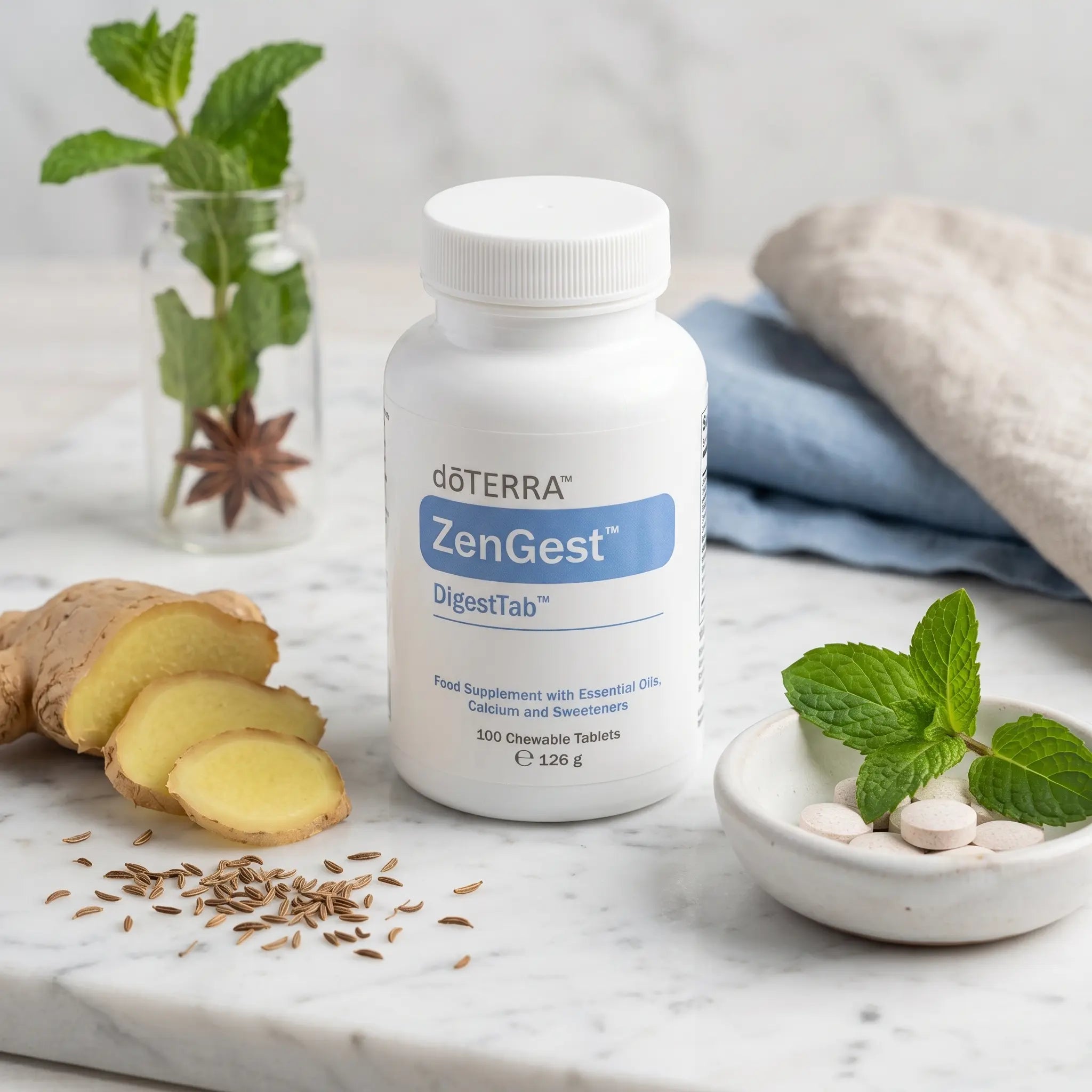 ZenGest DigestTab doTERRA 100 comprimidos en marmol blanco con jengibre laminado, semillas de comino y hojas de menta en cuenco ceramico